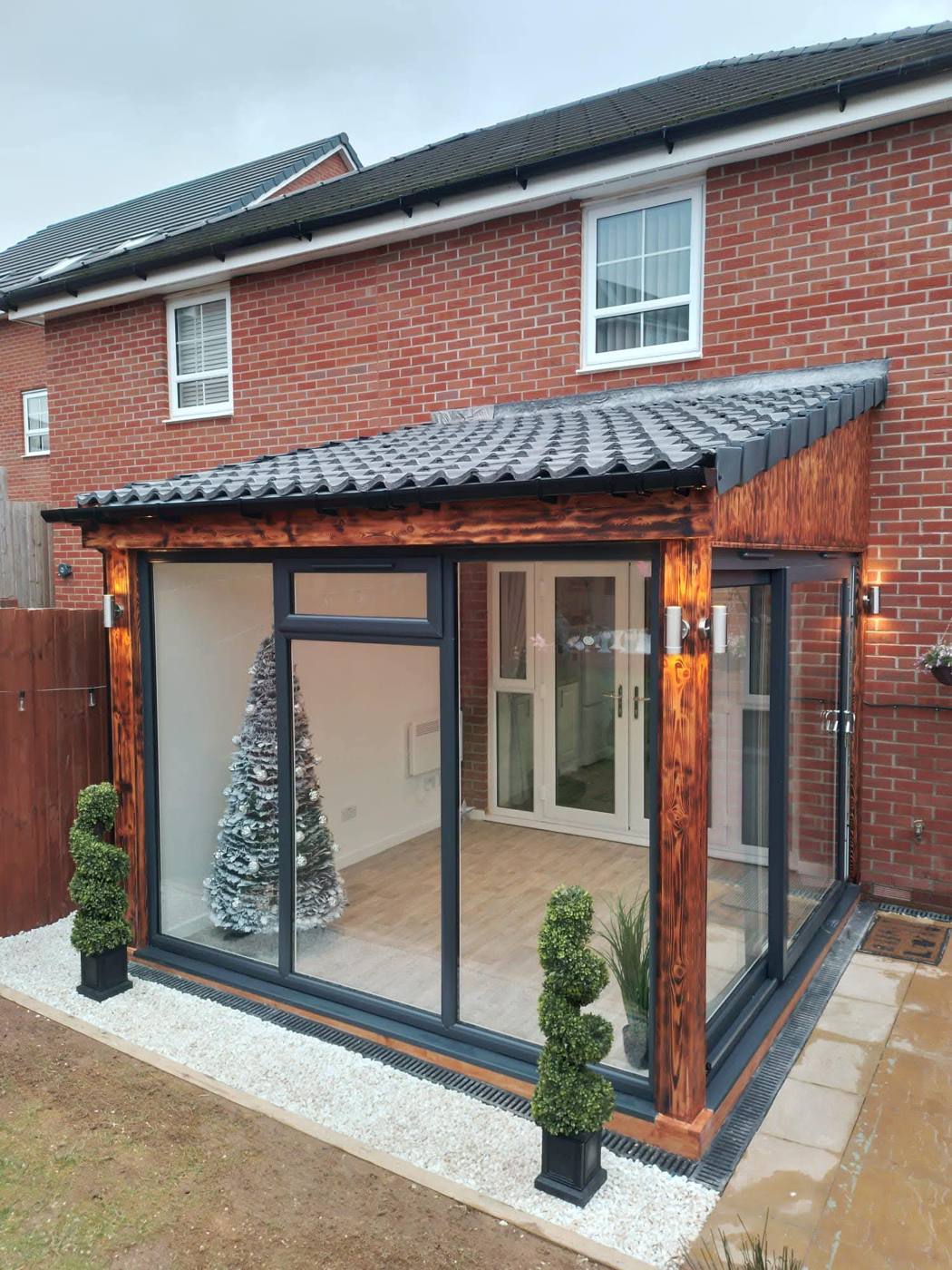 Glass sunroom with timber frame and tiled roof